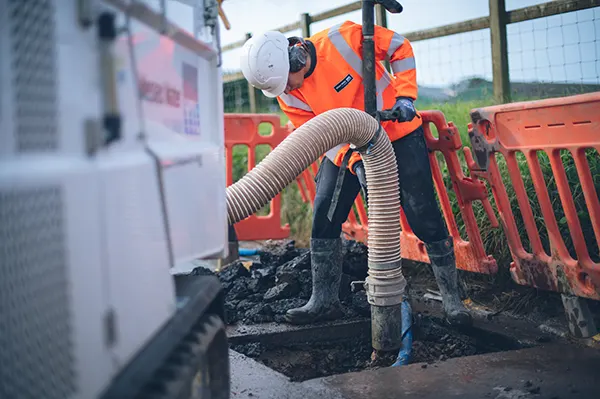 A picture of an employee fixing a leak