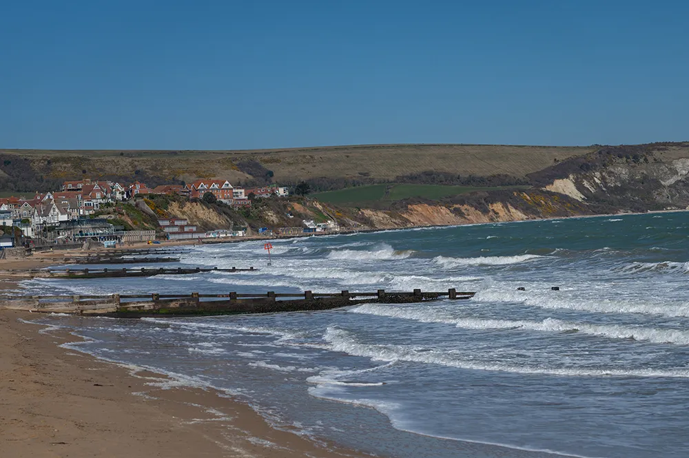 Small waves crashing on a beach in Dorset