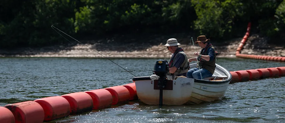 Two men fishing in boats on Clatworthy reservoir