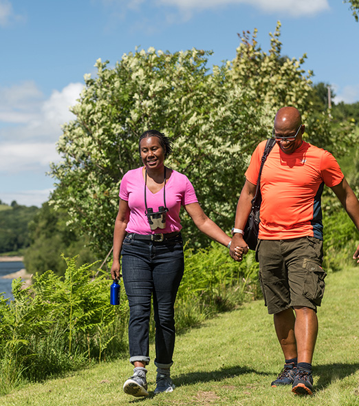 Couple holding hands and walking at Sutton Bingham Reservoir